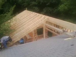 Framing a new roof addition that ties into an existing shingle roof in Whitharral